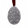 Decorative ornament with geometric pattern and embedded crystals on a white background