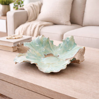 Large Handcrafted Low Tide Beach Porcelain Bowl decorative piece on a wooden coffee table with a living room background