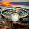 Bracelet with a circular design on a rock during sunset