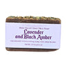 Bar of Moisturizing Goat Milk Soap with a lavender and black amber label on a white background
