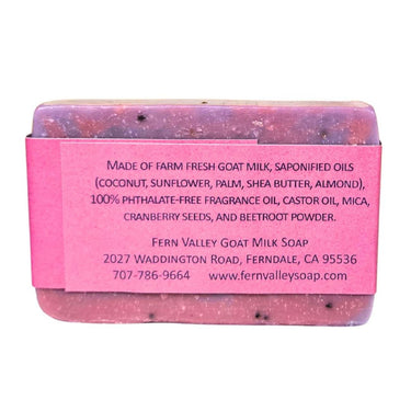 Bar of Divine Goat Milk Soap - Cranberry Seed Exfoliating Bar with a pink label displaying ingredients and contact information on a white background