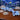 Ocean Coral Beach Sculpture in blue on a wooden surface with an aquarium in the background