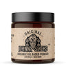 Jar of Johnny Glicks organic oil-based pomade with a black lid on a white background