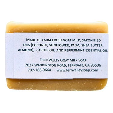 Bar of All Peppermint Natural Handmade Goat Milk Soap with a label detailing ingredients and contact information on a white background