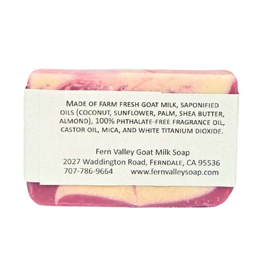 Bar of Feminine goat milk shower soap with sweet floral fragrance with a label detailing ingredients and contact information on a white background