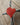 Red heart-shaped object on a wooden surface
