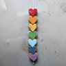 Colorful heart-shaped wooden ornament on a gray background