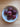 Bowl of plums on a wooden table