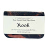 Bar of Charcoal goat milk soap for men with a woodsy scent with a label on a white background