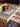 Jigsaw puzzle in progress with two mugs on a wooden table.