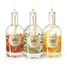 Three glass bottles with lit candles inside, each labeled with a different name, on a white background.
