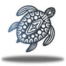 Decorative metal turtle with tribal patterns on a white background