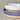 Two ceramic bowls, one white and one with a purple rim and beige base, on a neutral background.