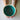 Teal ceramic bowl held by a person with tattoos on a light background