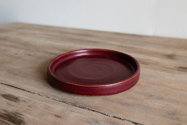 Red Earthenware Small Plate on a wooden surface