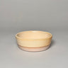 Ceramic bowl with a two-tone design on a gray background