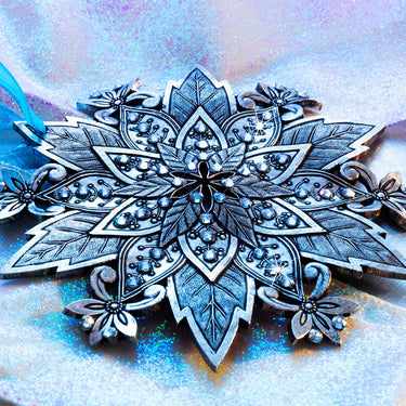 Decorative silver snowflake ornament on a textured blue and white background