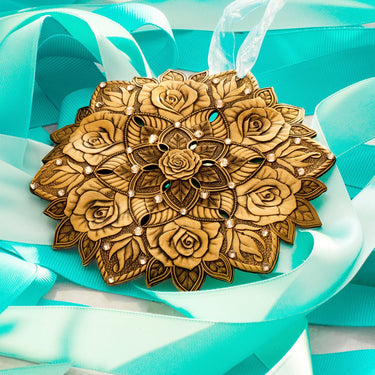 Decorative gold ornament with floral patterns on a turquoise ribbon background