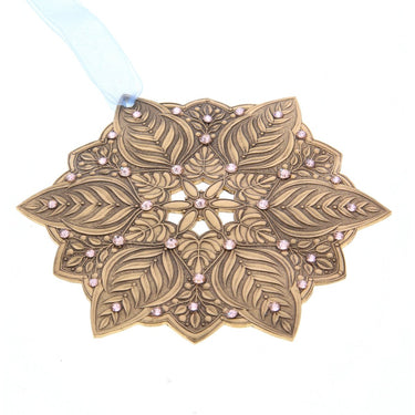 Decorative leaf-patterned ornament with pink beads on a white background