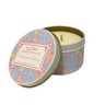 Candle in a decorative tin with floral design on a white background
