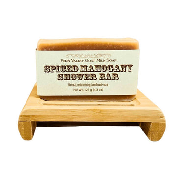 Spiced Mahogany Goat Milk Soap - shower bar on a wooden stand with a white background