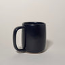 Black mug on a light gray background