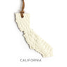 Decorative sign shaped like the state of California with a textured surface and 'California' text on a white background.