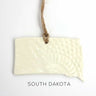 Rectangular ceramic sign with 'South Dakota' text on a white background