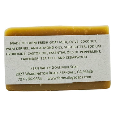 Bar of Humbug goat milk soap for showering and hand washing with a label detailing ingredients and contact information on a white background