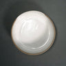 White ceramic plate on a dark gray background