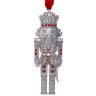 Decorative nutcracker ornament with red accents on a white background