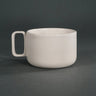 White ceramic mug on a dark gray background