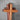 Wooden cross with layered wood design on a gray background