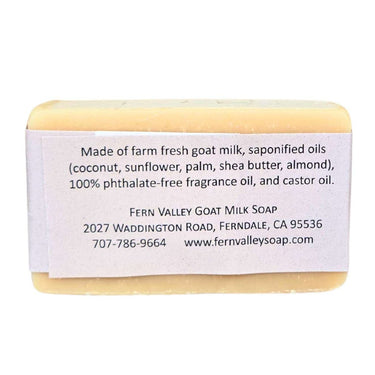 Bar of Smooth non exfoliating goat milk soap for daily shower with a label detailing ingredients and contact information on a white background