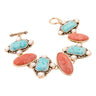 Pair of earrings with turquoise and pink stones on a white background