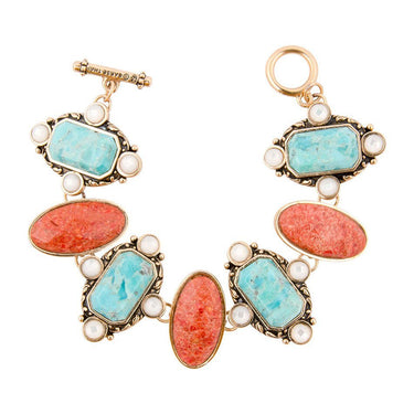 Pair of earrings with turquoise and coral stones on a white background