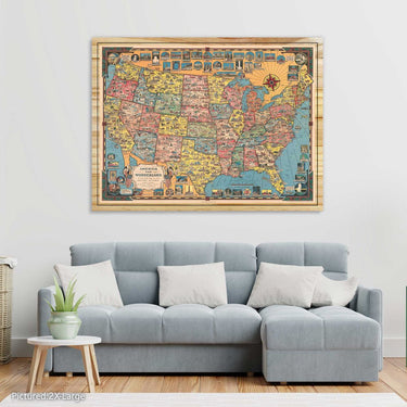 Colorful USA Map America the Wonderland 1954 Vintage Wood Art on a wall above a gray sofa in a living room.