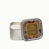 Warm Tobacco & Coriander Soy Lotion Candle in a decorative tin with a colorful label on a white background