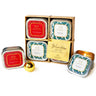 Set of four Winter 2 in 1 Soy Lotion Candles Holiday Scented Candle Gift Set in decorative tins with a gold box labeled 'Winter Gift Set' on a white background.