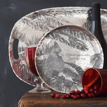 Decorative glass cutting board with cardinal design on a dark background